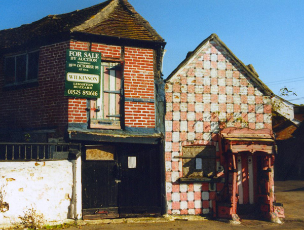 Forge and cottage with for sale sign